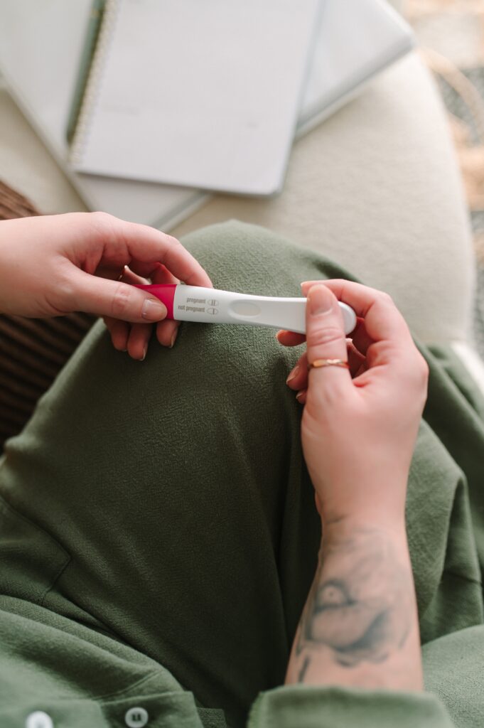 Detail photograph of someone holding a pregnancy test.