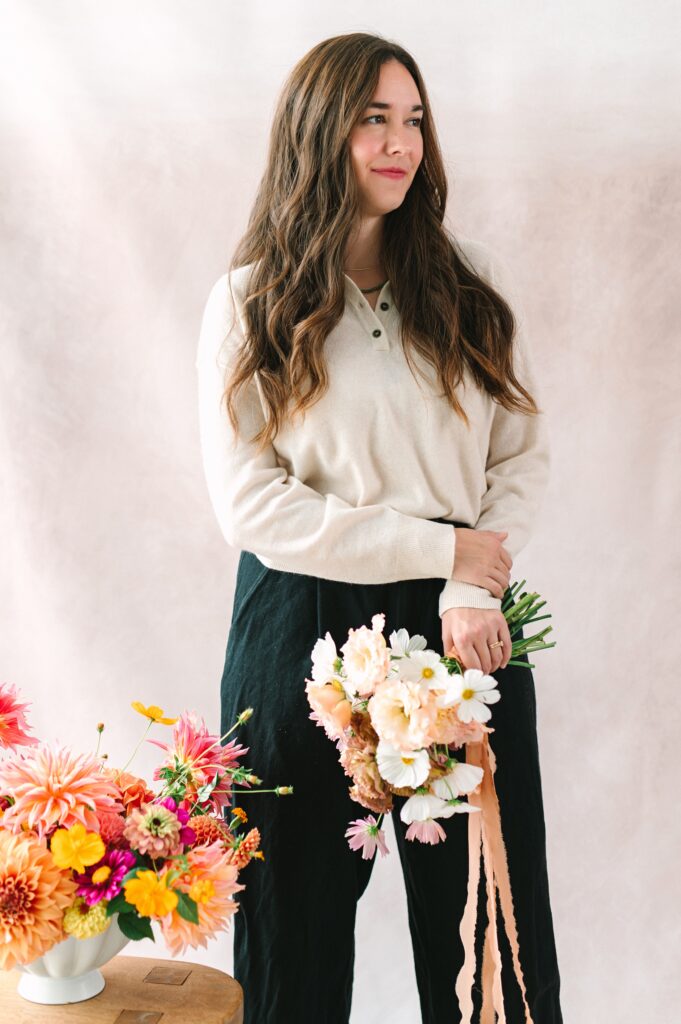 Detail photograph of a florist with a floral arrangement and bouquet.
