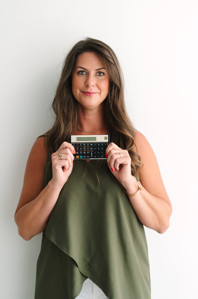 Headshot of a mortgage lending sales professional holding a vintage calculator.