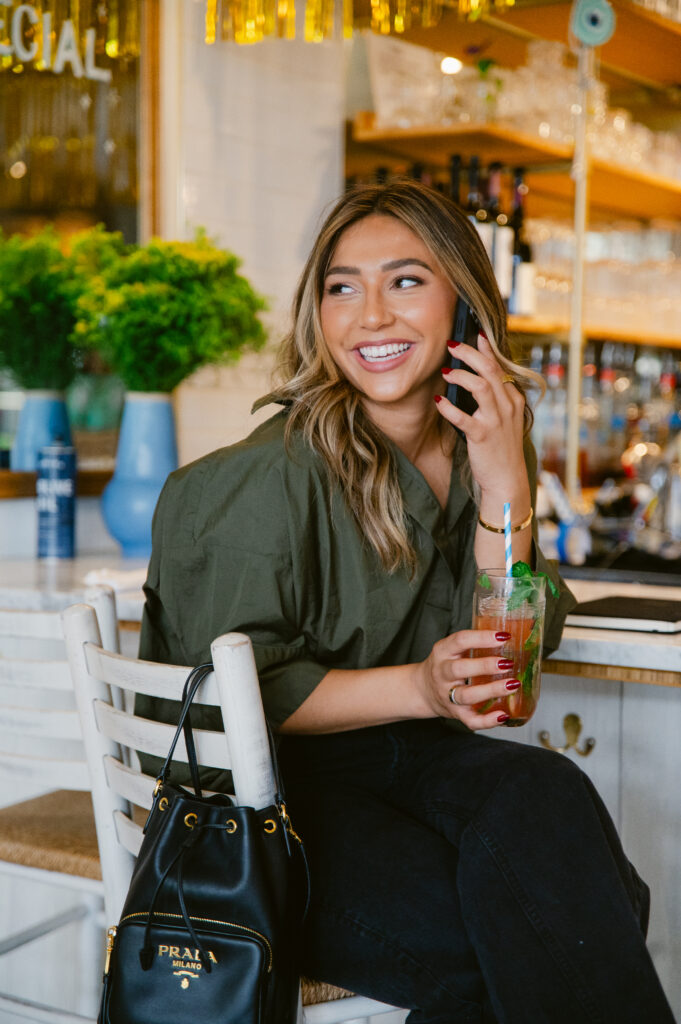 Branding photography lifestyle image of a woman chatting on the phone and enjoying a drink during her Richmond photoshoot.