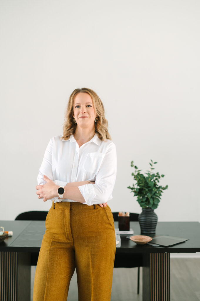 Woman posing confidently in a Richmond studio during her brand photoshoot.