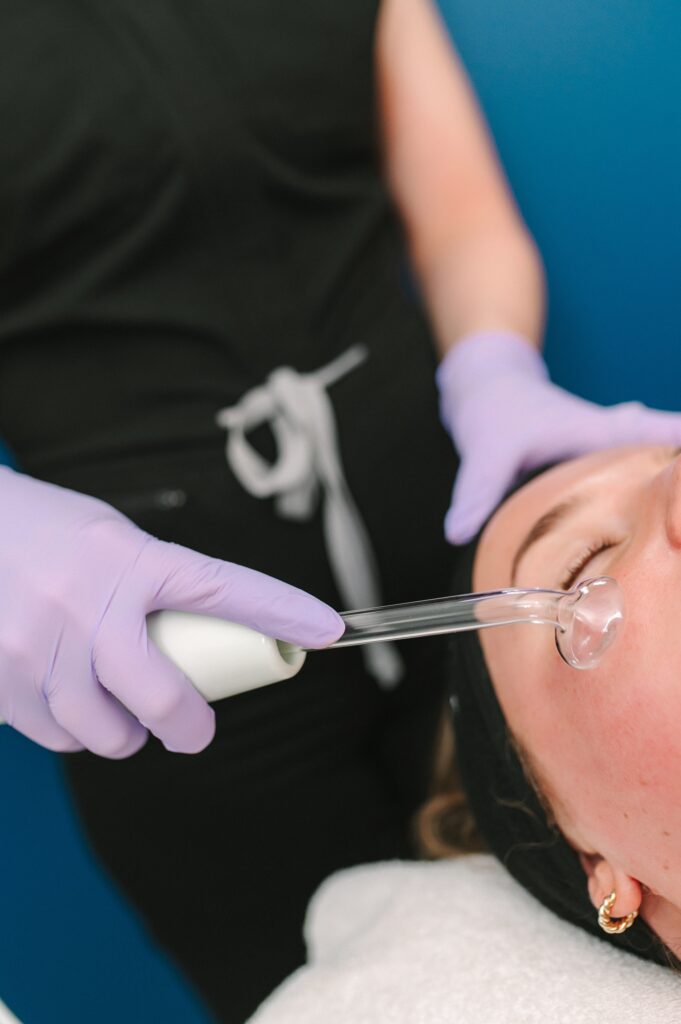 Detail shot of a facial treatment being performed by Skin by Victoria during a professional brand photoshoot.