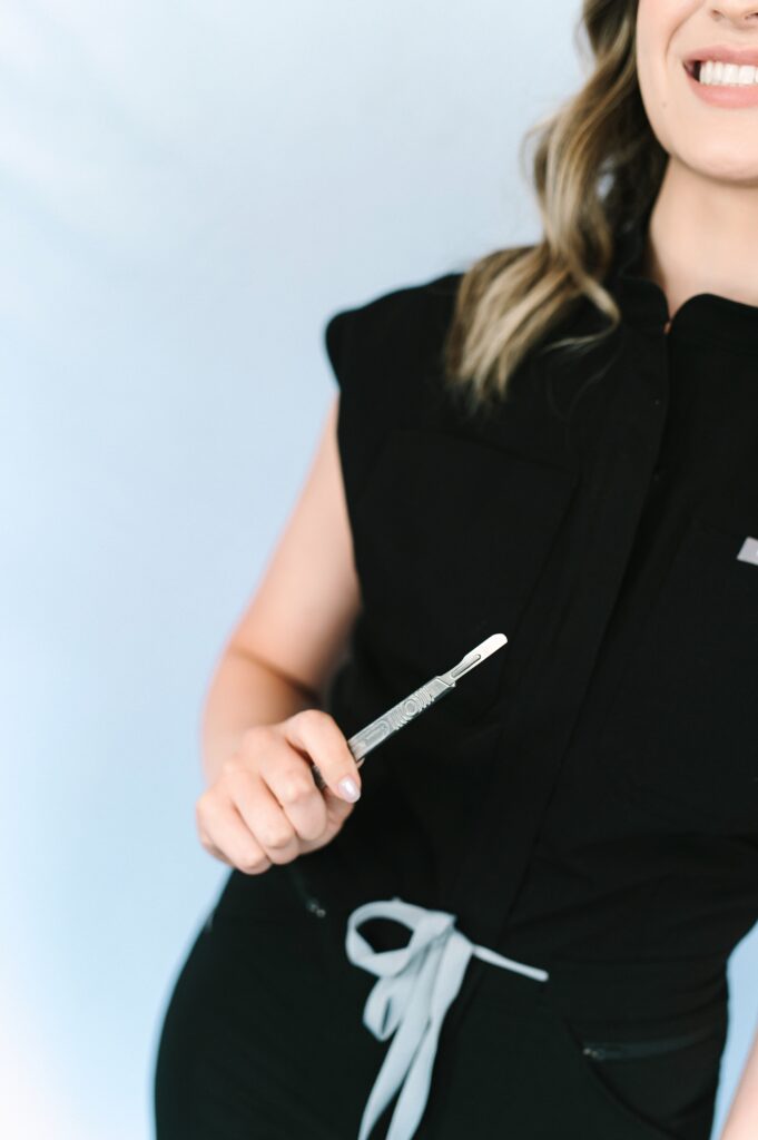 Close-up branding photo of Skin by Victoria holding a professional skincare tool during a Brand Gloss photoshoot.