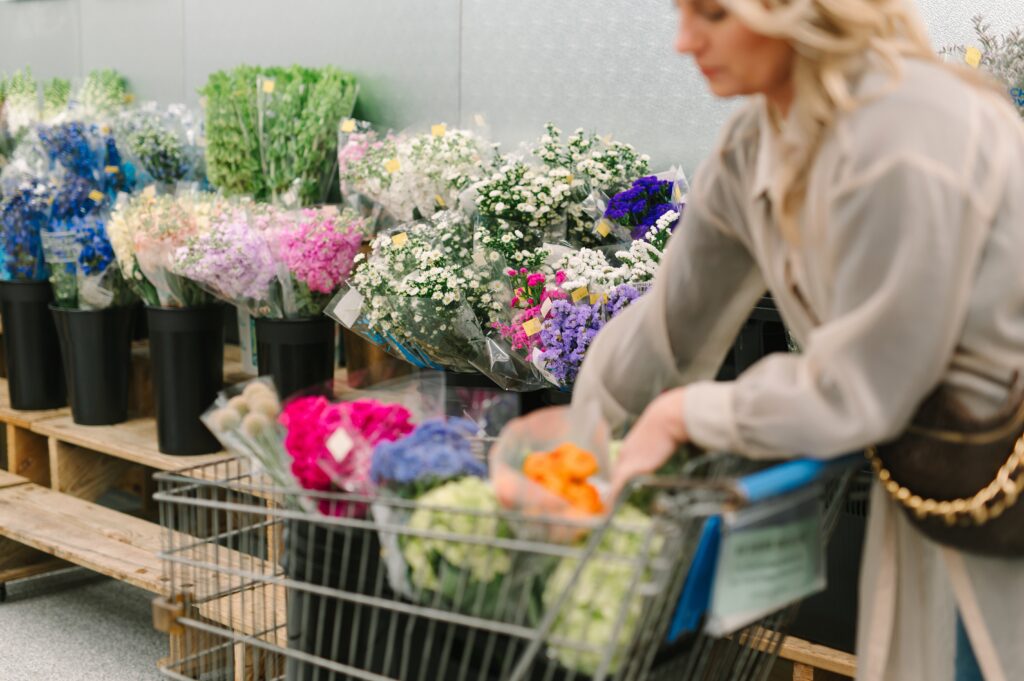 Retail customer shopping for flowers inside a flower market during branding photography.