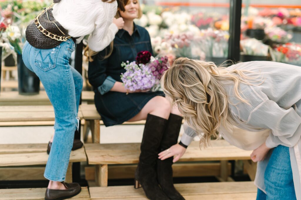 On-set wardrobe adjustments during branding photography for a flower market business