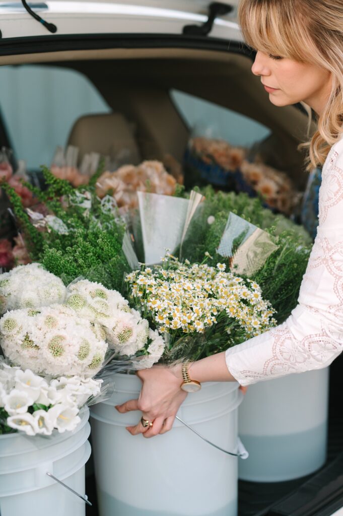 Behind the scenes branding photography showing flowers being loaded for delivery at a flower market.