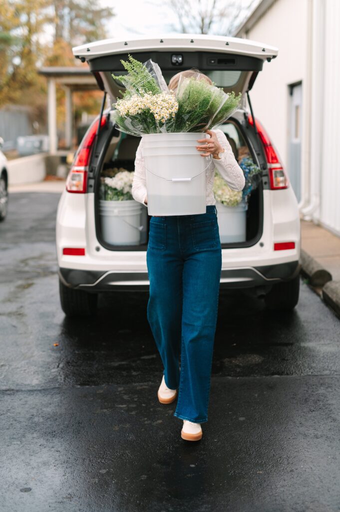 Close-up branding photography of fresh flower buckets being arranged for transport from Wholesale Flower Market.