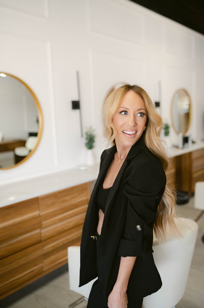 Close-up personal brand portrait of a hair stylist smiling confidently