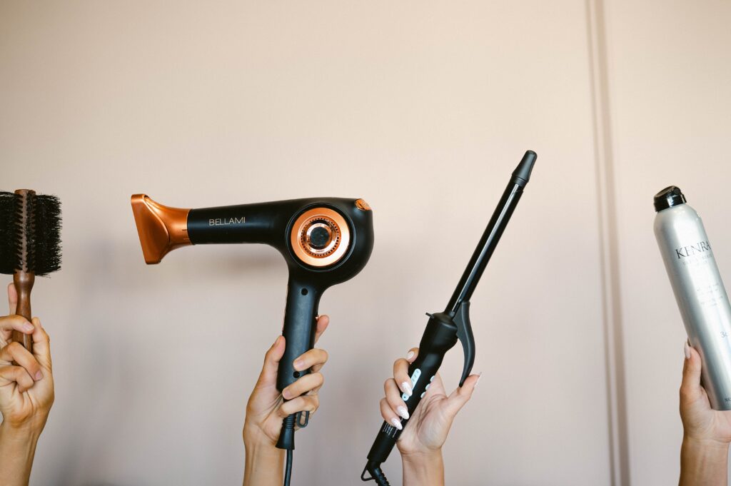 Makeup artist tools including blow dryer and curling iron styled for branding photography