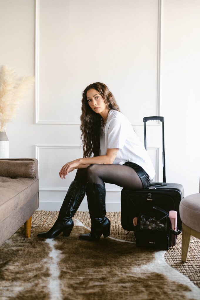 On-location hair stylist sitting with a rolling kit during a branding session