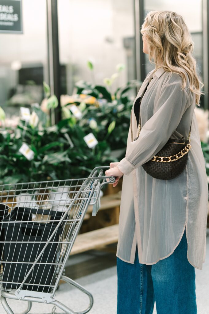 Customer browsing fresh flowers with a shopping cart inside Wholesale Flower Market in Richmond, VA.
