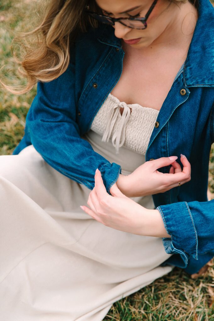 Close-up of boutique owner adjusting sleeve during a lifestyle branding photoshoot