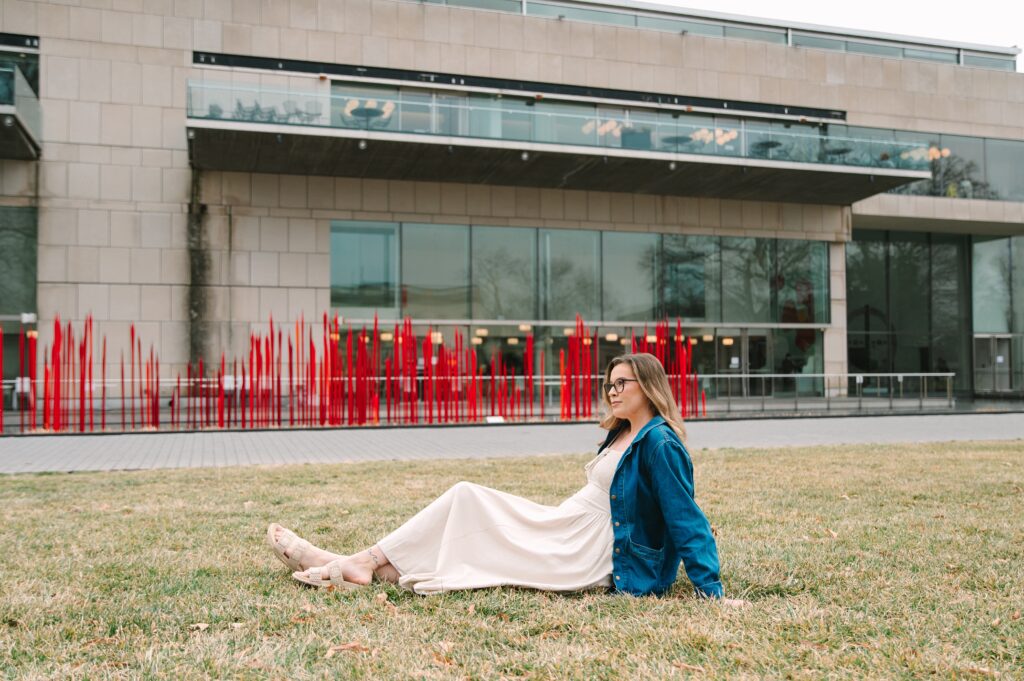 Boutique owner sitting on the VMFA lawn in her boutique clothing.