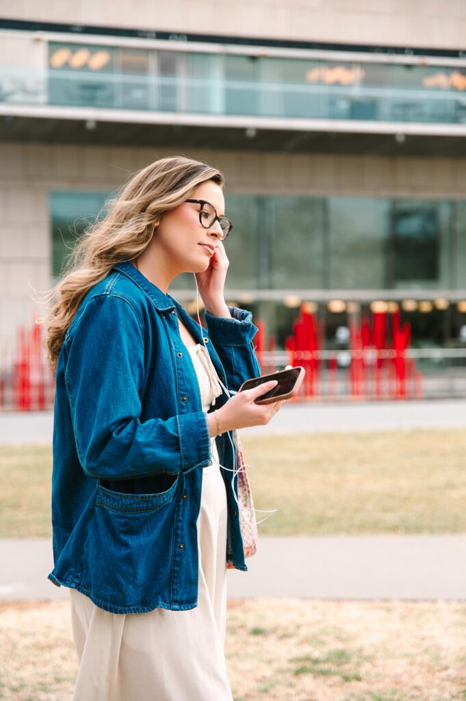 Boutique owner walking while using her phone during a lifestyle branding session in Richmond VA