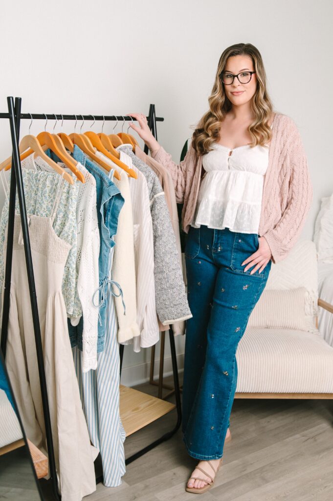 Boutique owner standing next to clothing rack during branding photoshoot in Richmond VA