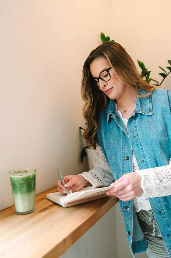 Boutique owner creating content at a coffee shop during branding photoshoot in Richmond VA