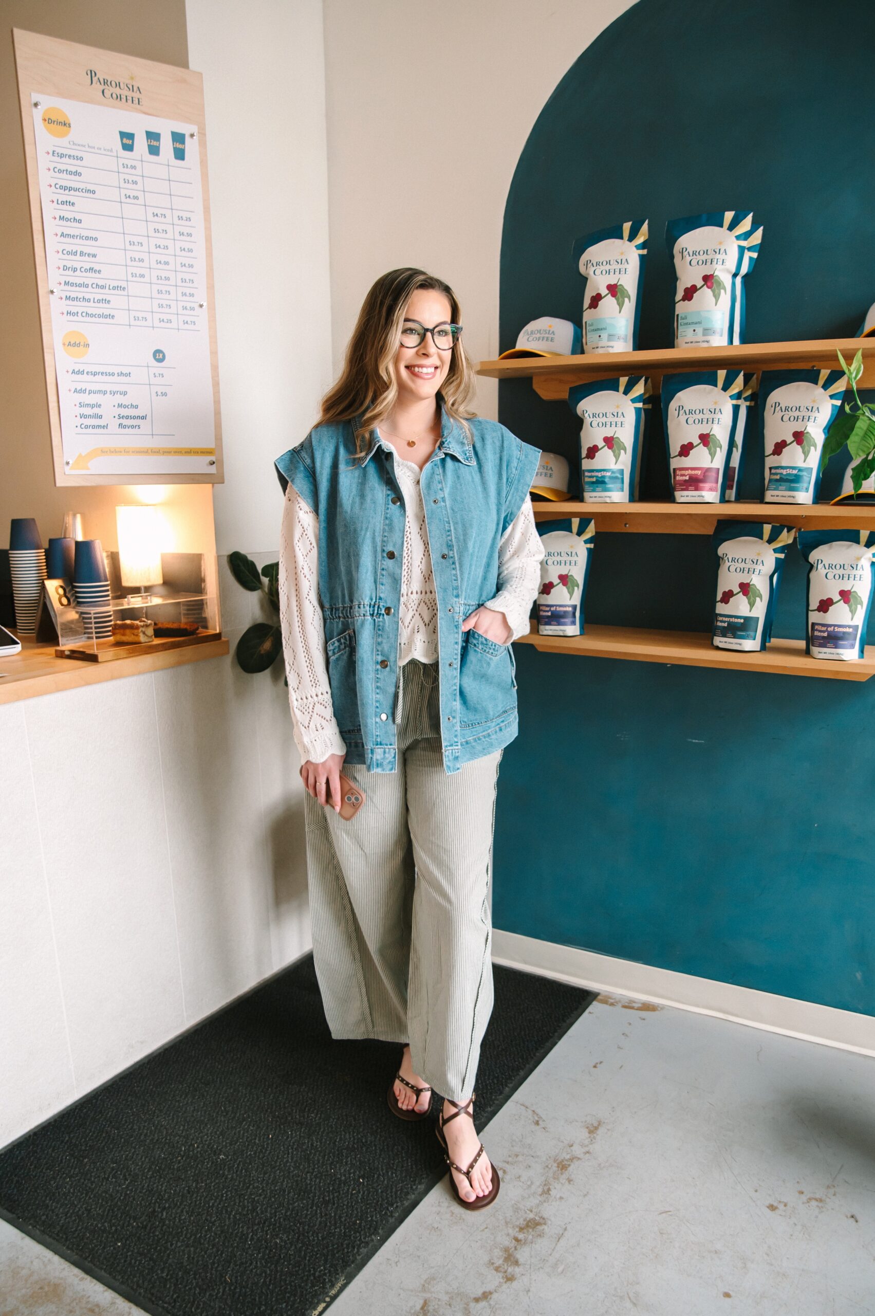 Boutique owner standing inside a coffee shop during a branding photoshoot in Richmond VA