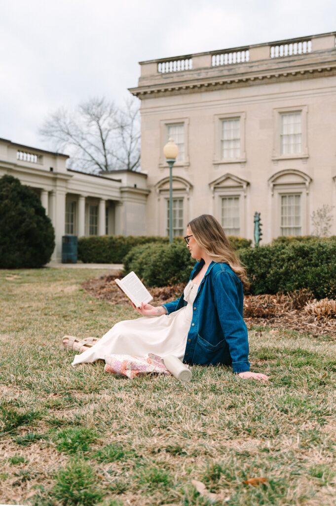 Boutique owner reading outside at VMFA during branding photoshoot in Richmond VA