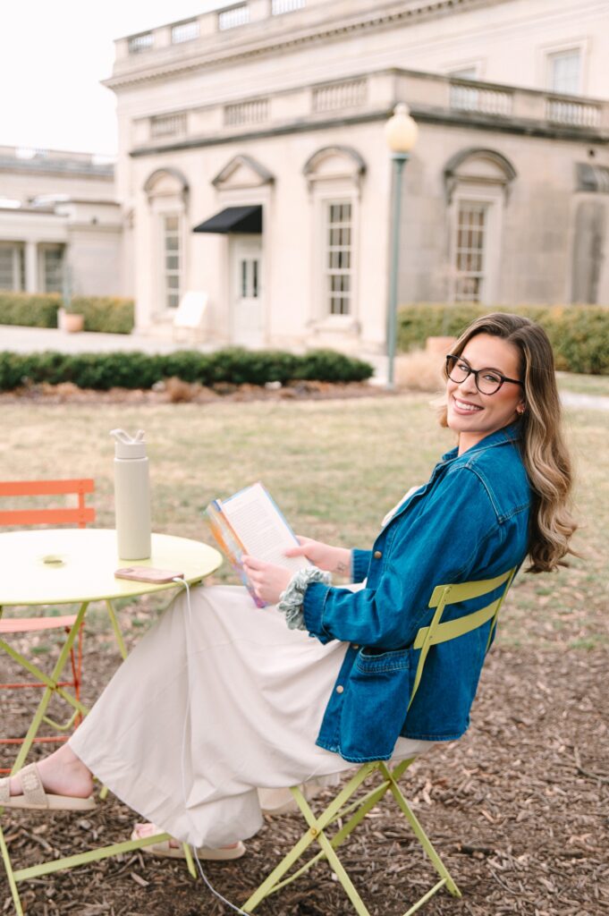 Boutique owner sitting outdoors reading during a branding photoshoot in Richmond VA