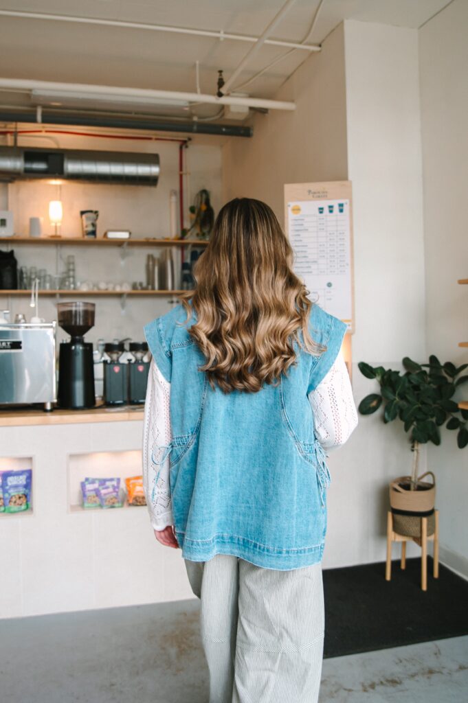 Boutique owner walking into a coffee shop during a branding session in Richmond VA