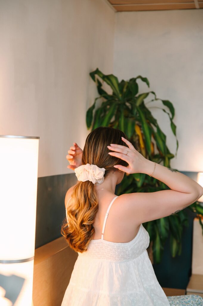 Boutique owner adjusting her hair during a branding photoshoot in Richmond VA
