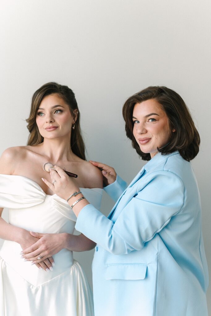 Luxury bridal makeup artist applying makeup to bride.