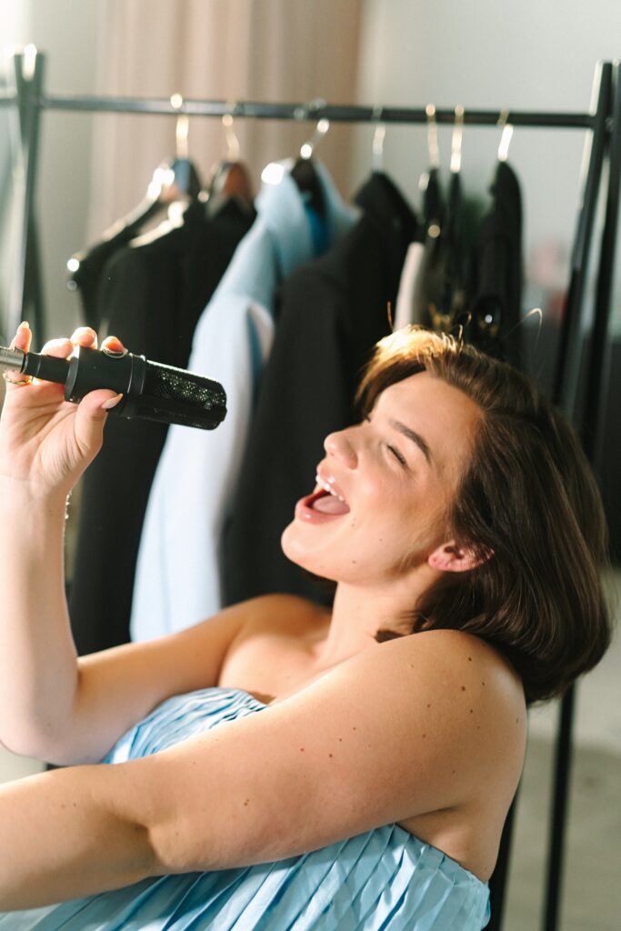 Creative branding photo of luxury bridal makeup artist singing into microphone photographed by a Richmond branding photographer.