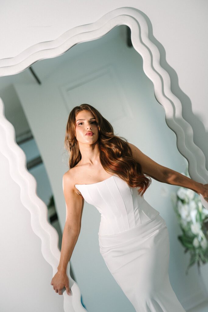 Bride posing in front of a mirror.