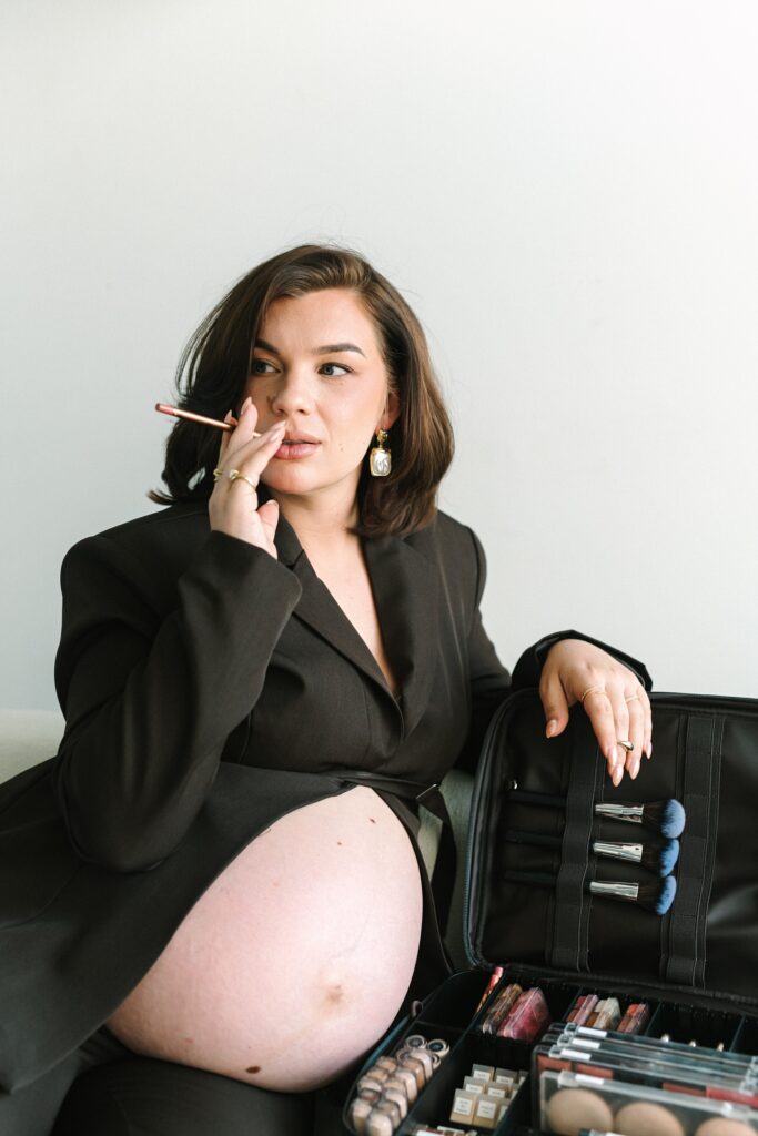 Luxury wedding makeup artist posing with professional makeup kit during personal branding session, photographed by a Richmond branding photographer.