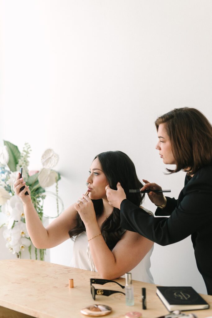 Makeup artist fixing a bride's hair