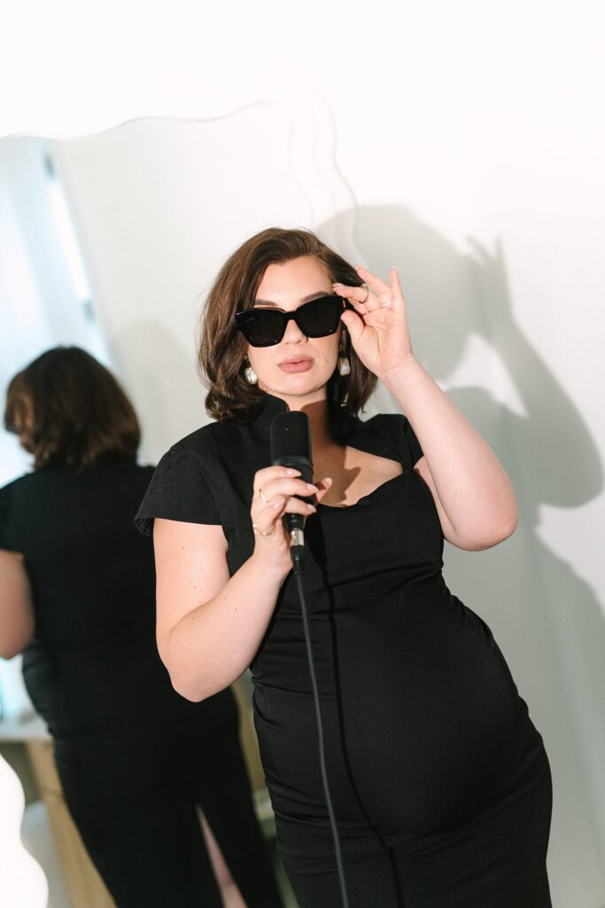 Editorial photo of a makeup artist holding a microphone.