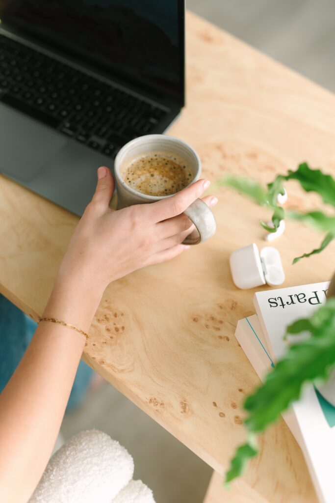 Detail shot of a cup of coffee at a desk during a branding photography session.