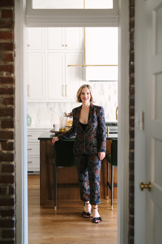 Lyndee McQuarrie walking through a custom-designed Richmond VA home during a branding photography session.