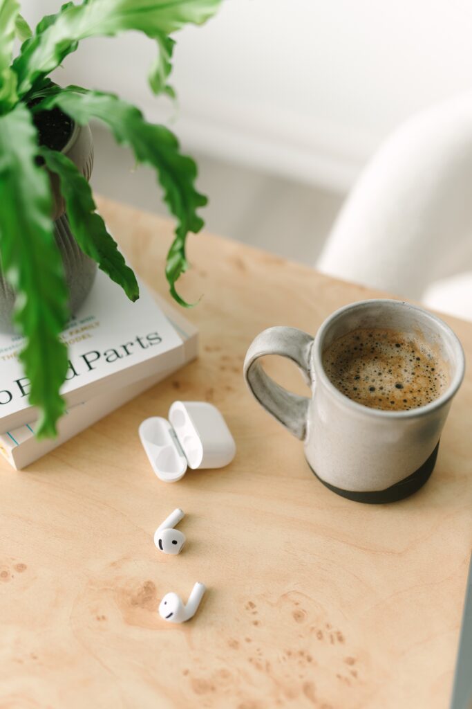 Detail photo of a cup of coffee and ear buds in a branding photography session for a therapist.