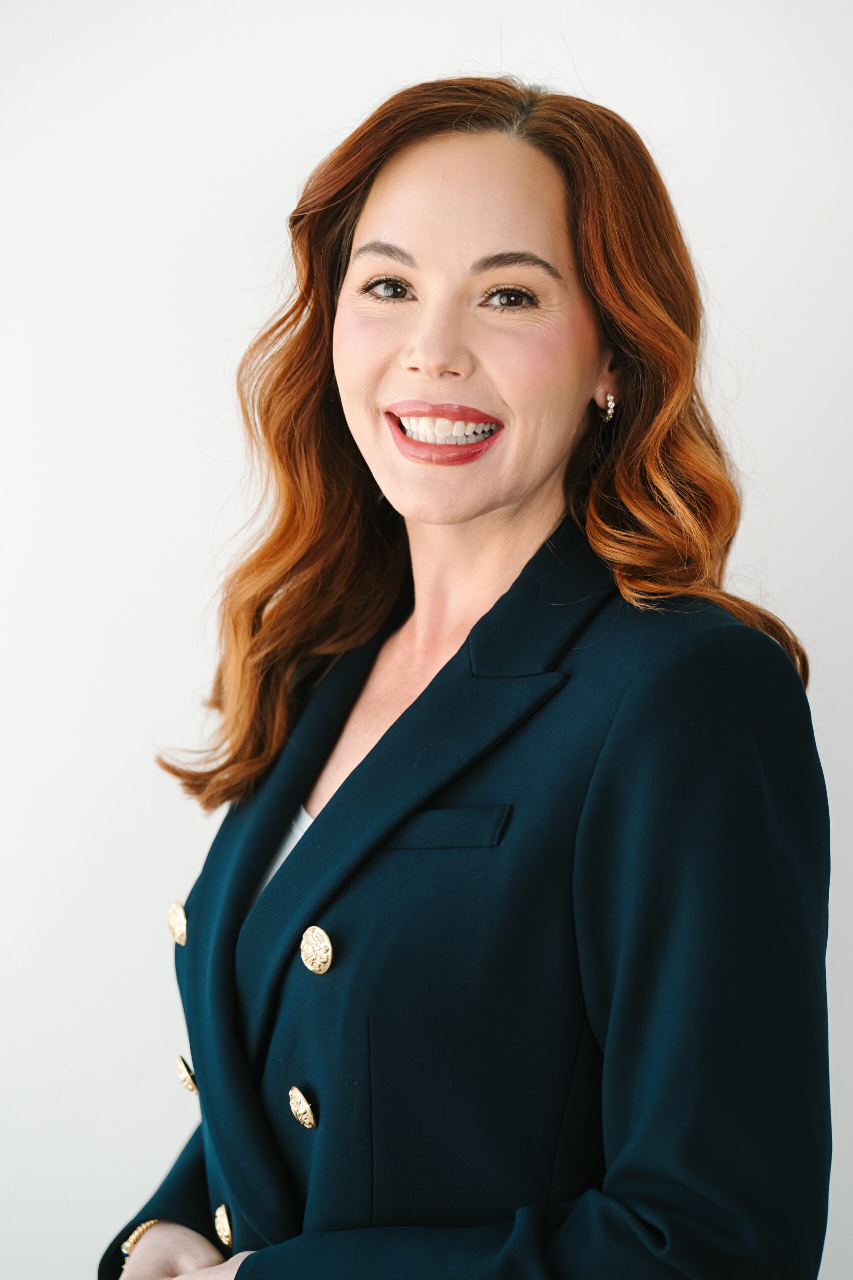 Professional headshot in Richmond VA of a woman in leadership wearing a navy blazer