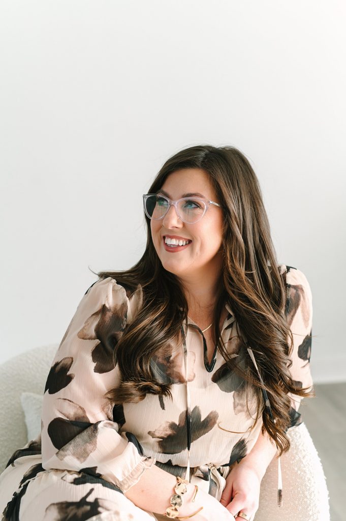 Professional headshot of a smiling Sparrow Home Loans team member in a neutral floral blouse looking off camera, Richmond VA